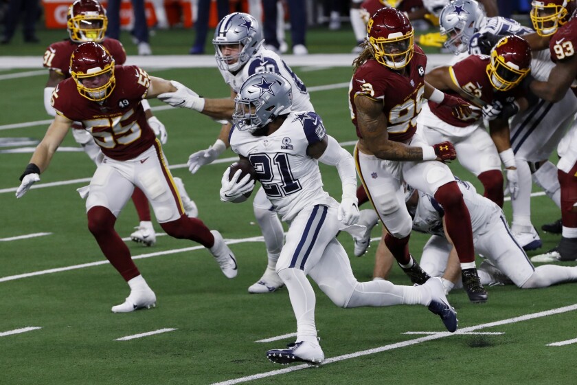 FILE - Dallas Cowboys running back Ezekiel Elliott (21) carries the ball as Washington Football Team's Cole Holcomb (55) and Chase Young (99) give chase during the second half of an NFL football game in Arlington, Texas, Nov. 26, 2020. The teams meet Sunday at Washington. Elliott has been held under 50 yards rushing in four consecutive games for the first time in his career, and Dallas is 2-2 during this stretch, including an overtime loss to Las Vegas. (AP Photo/Roger Steinman, File)