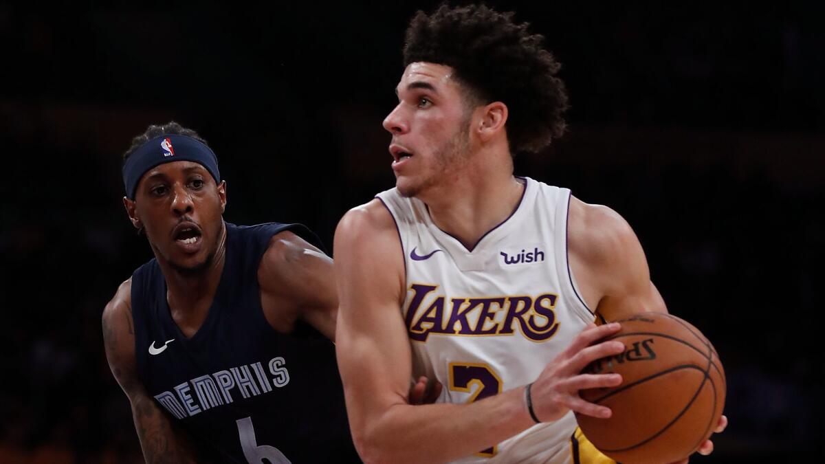 Lakers guard Lonzo Ball drives to the basket against Grizzlies guard Mario Chalmers in the first quarter.