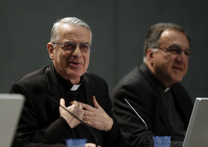 Vatican spokesman the Rev. Federico Lombardi, left, meets the media at the Vatican on Friday.