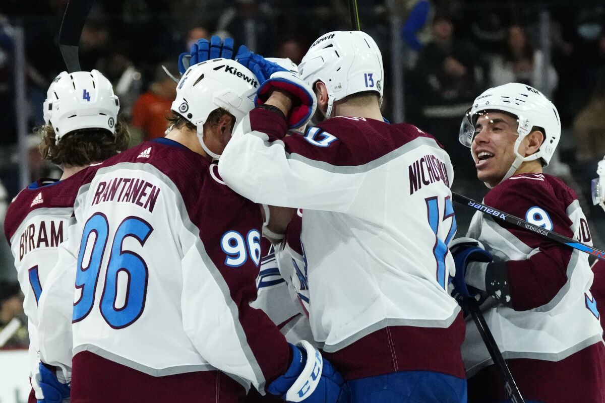 Colorado Avalanche right wing Valeri Nichushkin (13) celebrates after his winning goal against the Arizona Coyotes with Avalanche right wing Mikko Rantanen (96) and center Evan Rodrigues (9) in a shootout of an NHL hockey game Sunday, March 26, 2023, in Tempe, Ariz. (AP Photo/Ross D. Franklin)