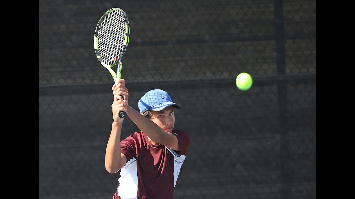 Laguna Beach High's Mason Lebby rips a backhand from the baseline in boys' tennis match against Hacienda Heights Wilson in the first round if the CIF Southern Section Division 4 playoffs on Wednesday.