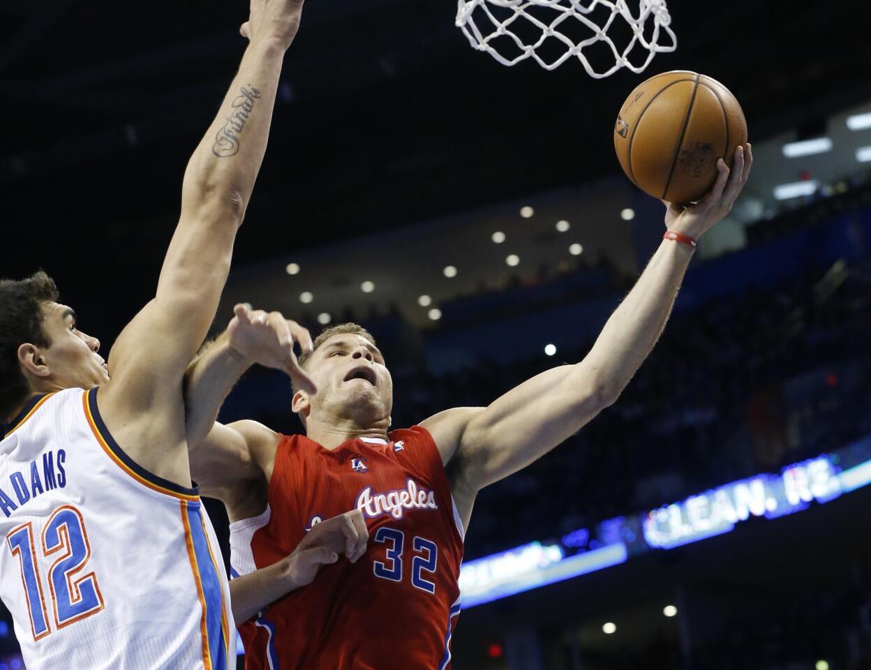 Clippers power forward Blake Griffin drives to the basket against Thunder center Steven Adams in the first half.