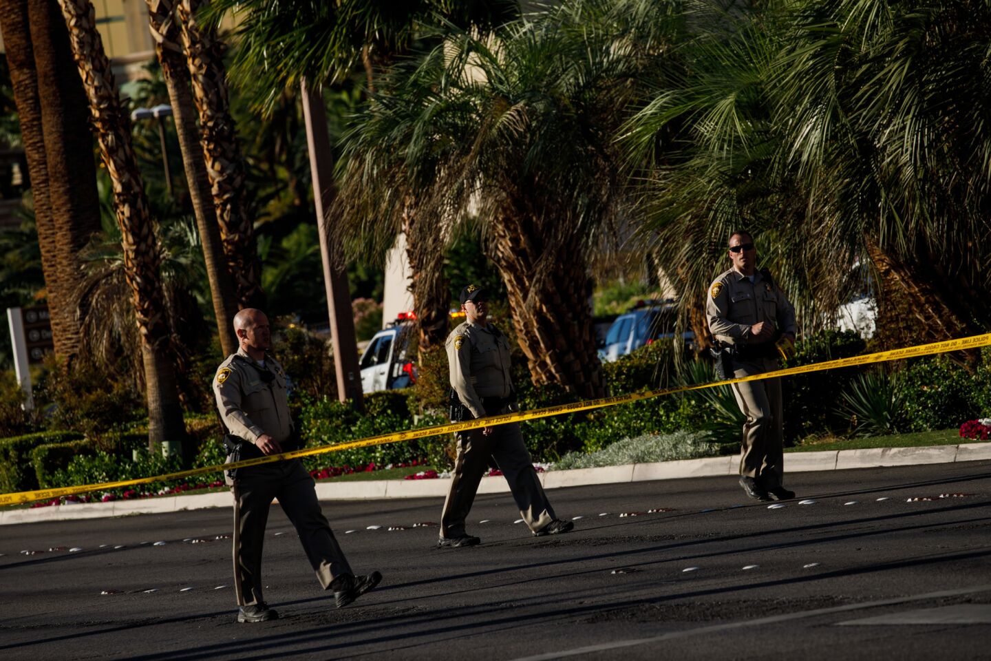 Law enforcement officers in Las Vegas on Monday cordon off a crime scene after a gunman opened fire from an upper story hotel room on a country music festival the night before.