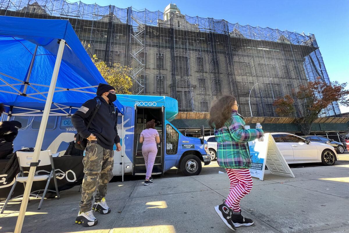 A girl walks outside a mobile vaccine unit in New York City.