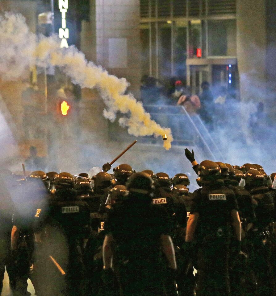 Police fire tear gas as protesters converge in downtown Charlotte, N.C., the day after the police shooting of Keith Lamont Scott.