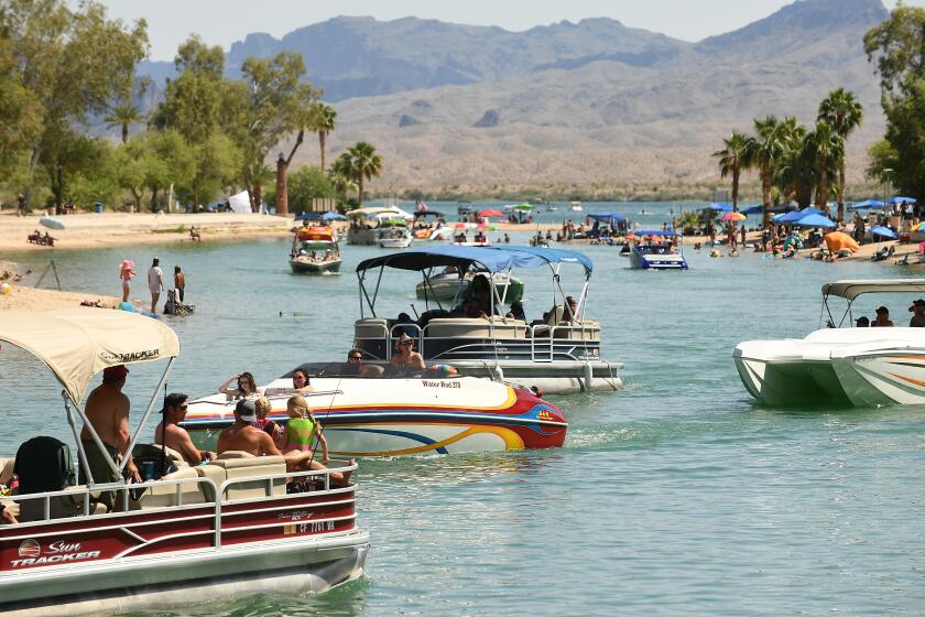 LAKE HAVASU, ARIZONA MAY 9, 2020-Boats pass through a chanel during a hot day in Lake Havasu City, Arizona. The city has been crowded by an influx of Californians over the past few weekends as residents are concerned about the cornavirus spreading but also want the economy open. (Wally Skalij/Los Angeles Times)