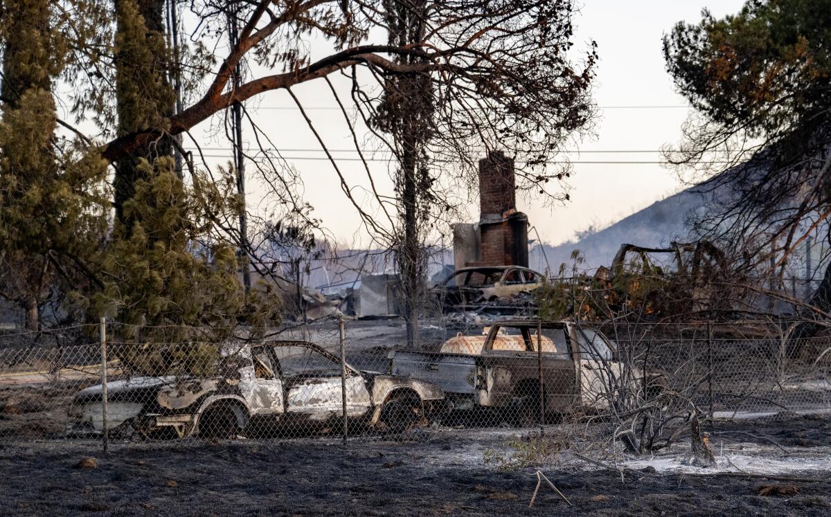 Multiple cars and a home are destroyed by the Juniper fire.