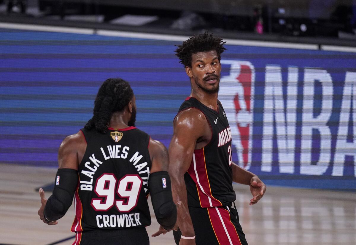 Miami Heat's Jimmy Butler, right, and Jae Crowder talk between plays during Game 3 of the NBA Finals against the Lakers.