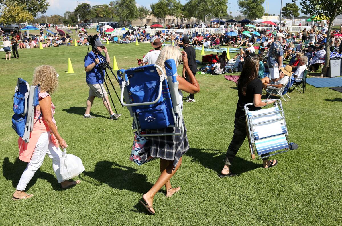 Guests arrive with beach chairs on the grass during the return of  "Concert in the Park." 