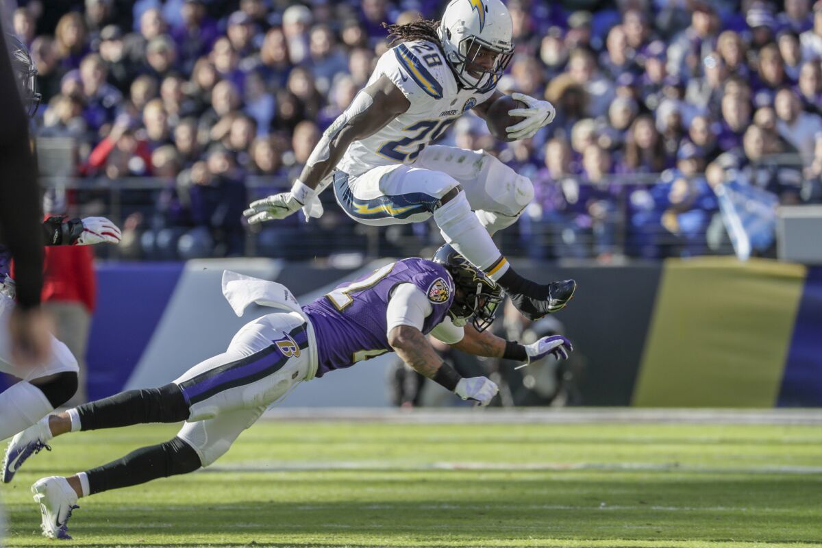 Chargers running back Melvin Gordon leaps over Baltimore Ravens cornerback Jimmy Smith for a short gain during the first half of a wild-card game.