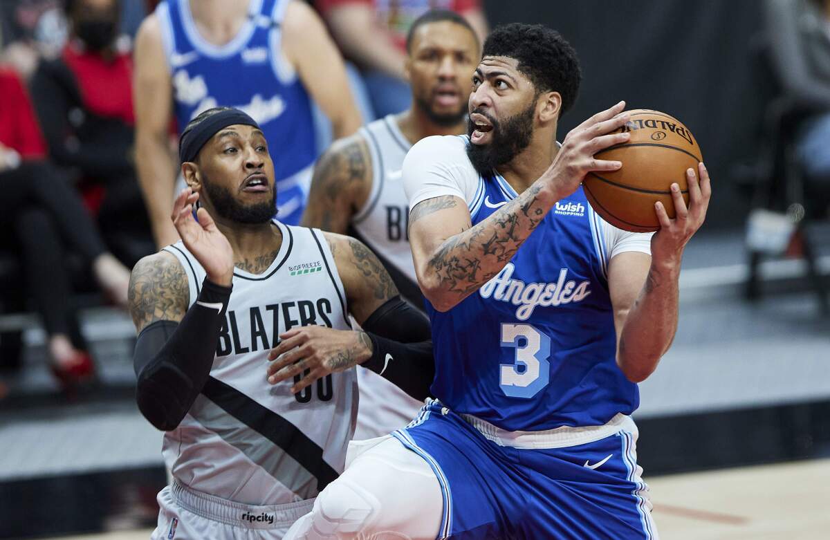 The Lakers' Anthony Davis drives against the Trail Blazers' Carmelo Anthony during the first half May 7, 2021.