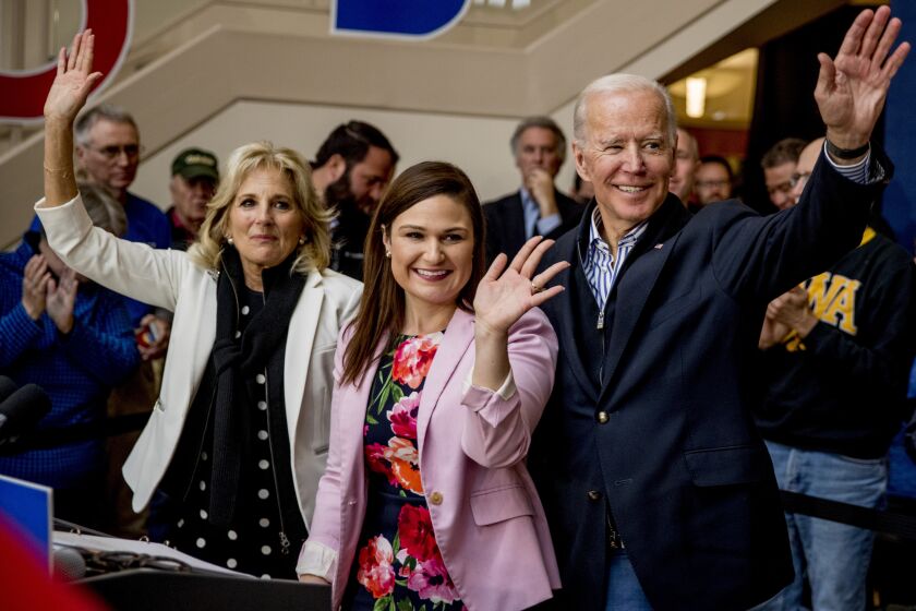 Democratic presidential candidate Joe Biden, right, his wife Jill Biden, left, and Rep. Abby Finkenauer, D-Iowa, center, wave at the conclusion of a campaign speech at the University of Dubuque, Friday, Jan. 3, 2020, in Dubuque, Iowa. (AP Photo/Andrew Harnik)