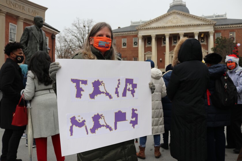 Amanda SubbaRao holds a sign calling for “Fair Maps” during a rally in Annapolis, Md., on Wednesday, Dec. 8, 2021