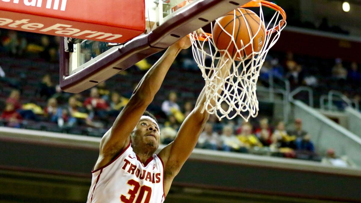 USC Guard Elijah Stewart dunks an alley-oop pass from teammate De'Anthony Melton (not pictured) during the win over UC Santa Barbara on Sunday.