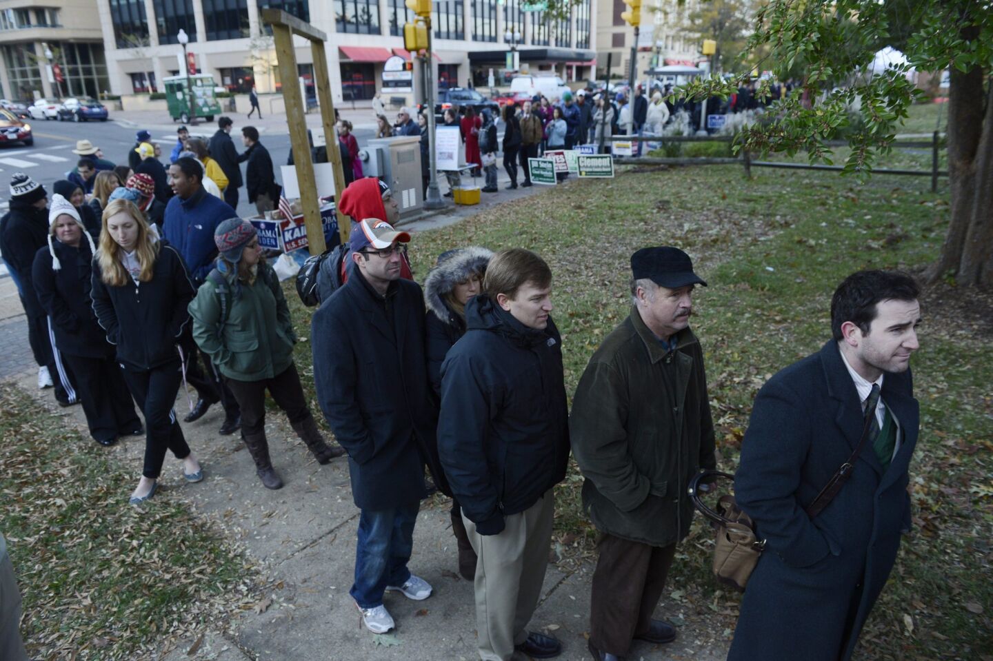 People wait in an estimated two-hour long line, that goes down the street and around the block, to vote at a polling site in Arlington, VA.
