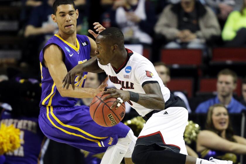 Louisville guard Terry Rozier drives past Northern Iowa guard Jeremy Morgan in the first half of the Cardinals' 66-53 victory over the Panthers on Sunday.