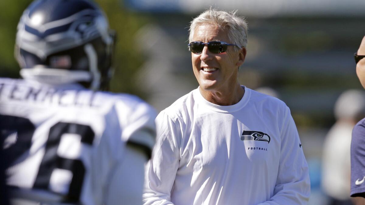 Seattle Seahawks Coach Pete Carroll looks on during a training camp session in Renton, Wash., on July 29. For Carroll, winning the Super Bowl is a byproduct of achieving an even greater goal.
