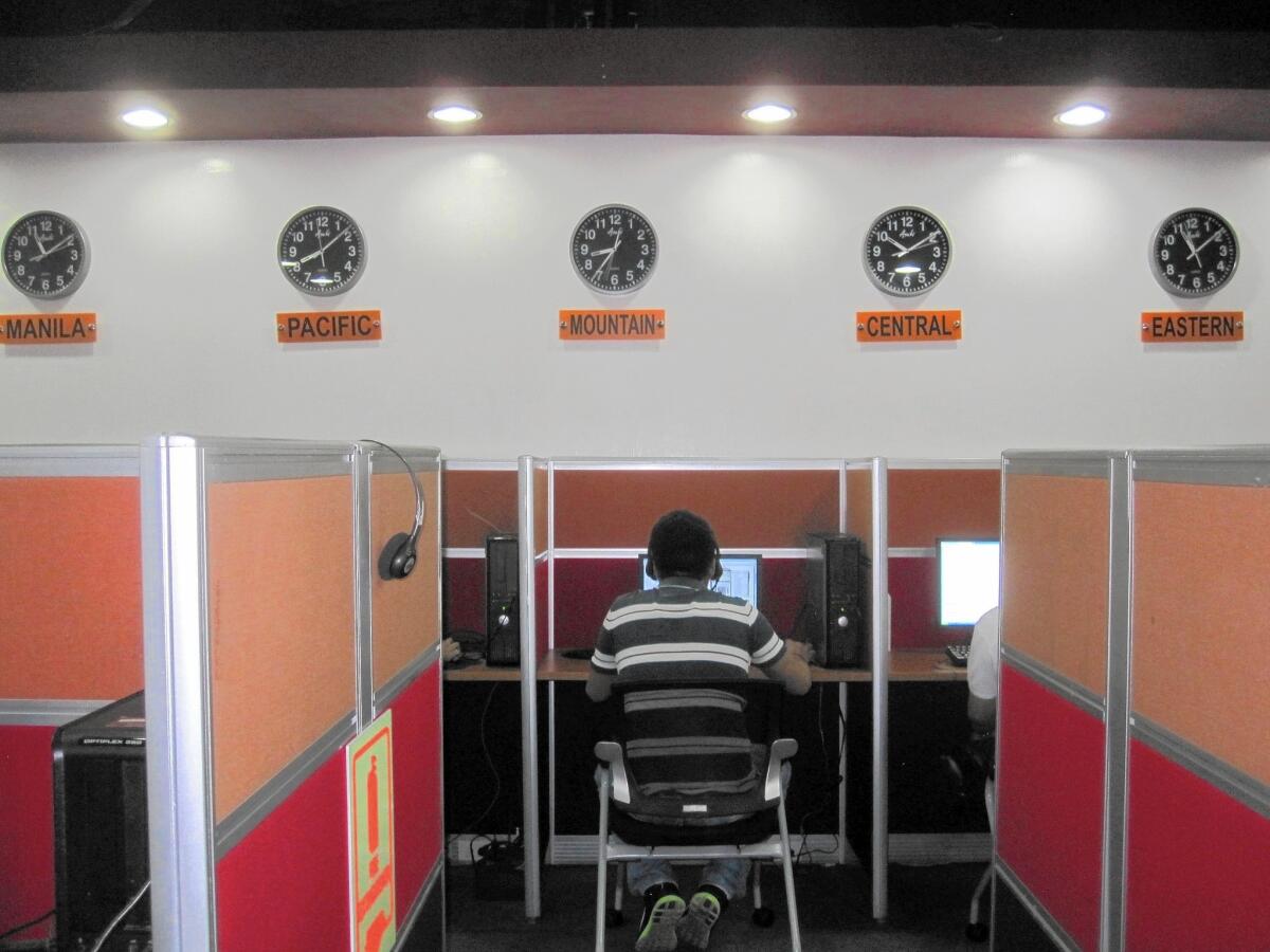 Workers at Visaya Knowledge Process' call center in central Manila sit shoulder to shoulder as they speak with people in the United States. A tote board on one wall tracks in-coming calls as well as metrics like the time spent with each customer.