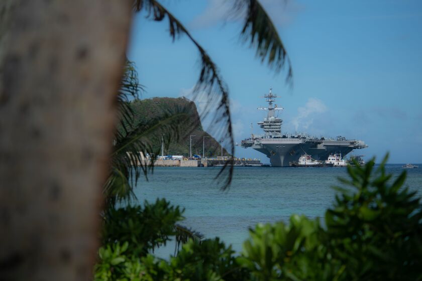 The aircraft carrier Theodore Roosevelt (CVN 71) transits Apra Harbor as the ship prepares to moor in Guam in 2019. The ship returned to Guam on Thursday after several sailors tested positive for COVID-19.