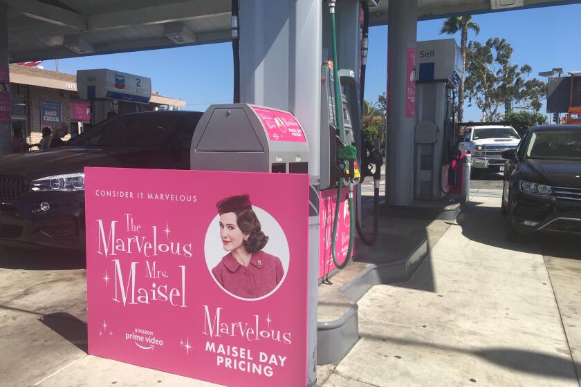 A "Maisel Day" promo poster at a Chevron in Santa Monica.