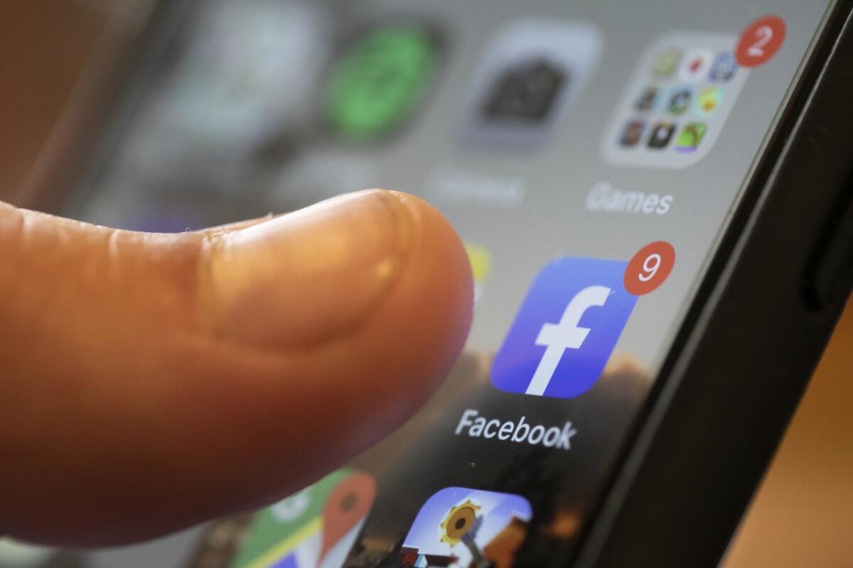 FILE - An iPhone displays the Facebook app in New Orleans, Aug. 11, 2019. Facebook failed to detect election-related misinformation in ads ahead of Brazil's 2022 election, a new report from Global Witness has found, continuing a pattern of not catching material that violates its policies the group says is “alarming.” (AP Photo/Jenny Kane, File)