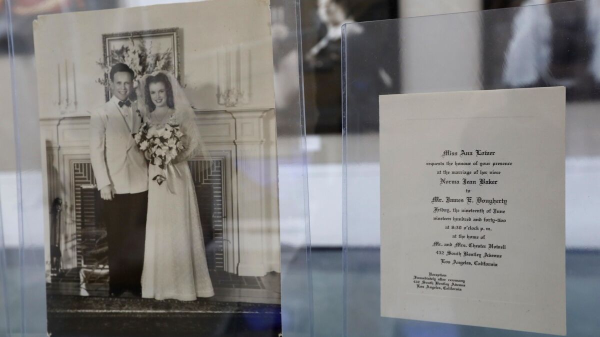 A marriage photo of Norma Jean Baker and her first husband James Dougherty displayed next to the wedding invitation are part of the exhibit.