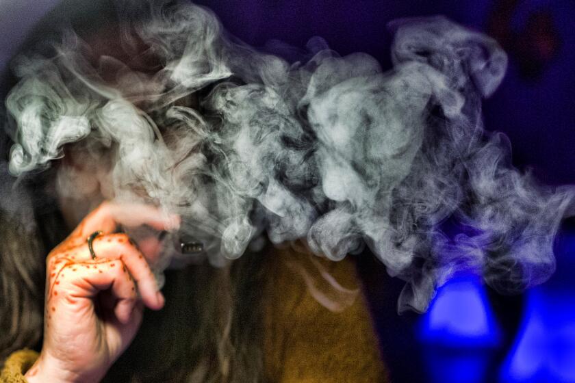 FILE - In this Saturday, Dec. 22, 2018 file photo, a woman takes a puff from a cannabis vape pen in Los Angeles. On Friday, Sept. 6, 2019, U.S. health officials are again urging people to stop vaping until they figure out why some are coming down with serious breathing illnesses. (AP Photo/Richard Vogel)