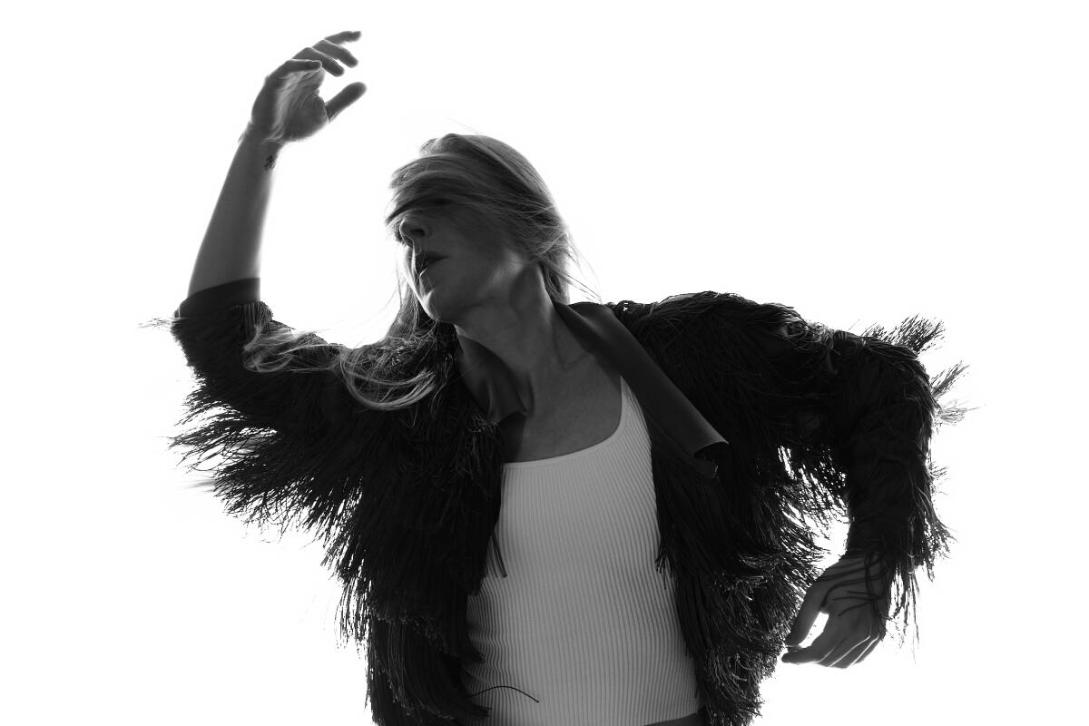 Jenn Freeman dances with a scarf tied over her eyes.