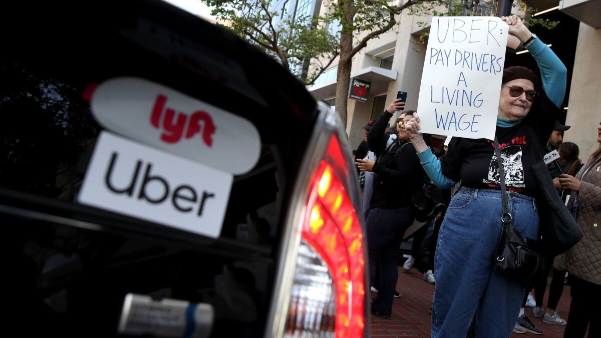 A demonstrator outside Uber headquarters in San Francisco in May.