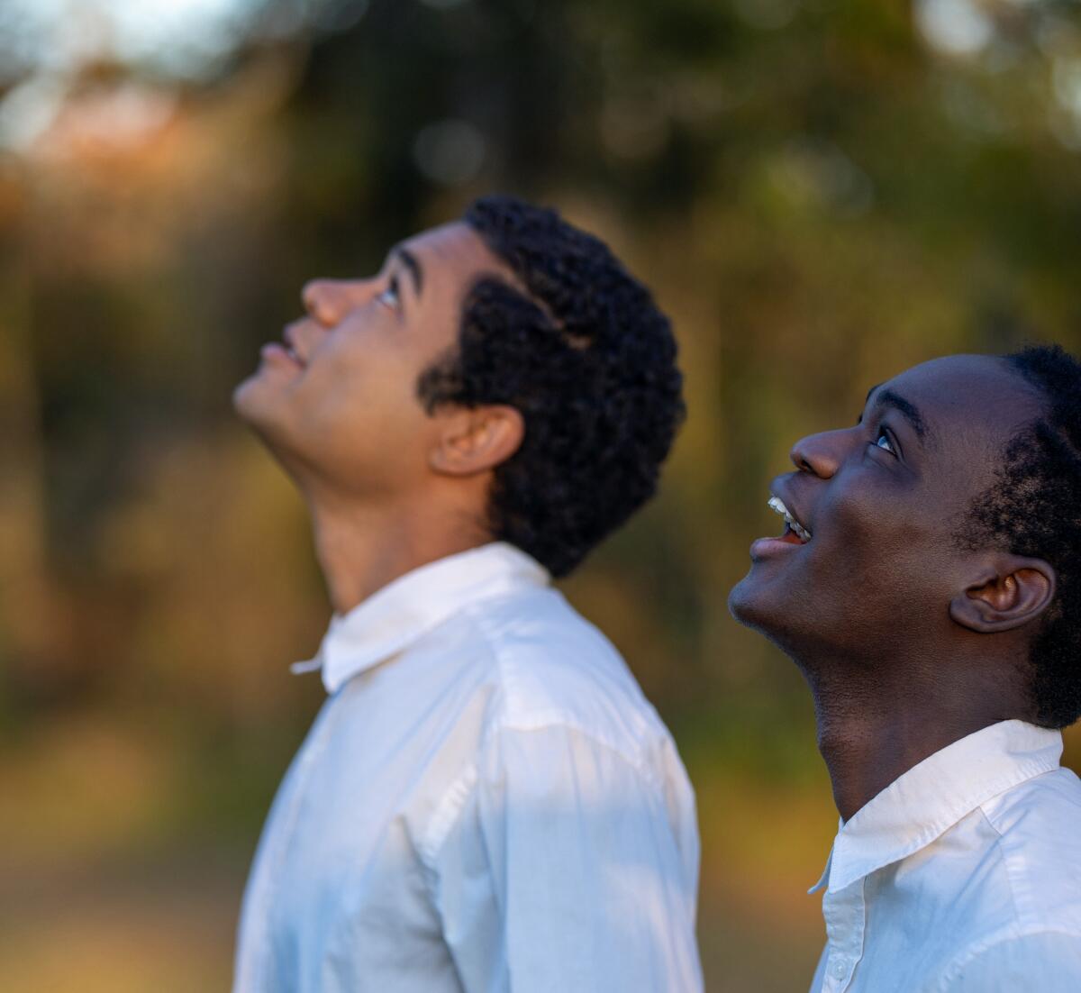 Two boys look skyward.