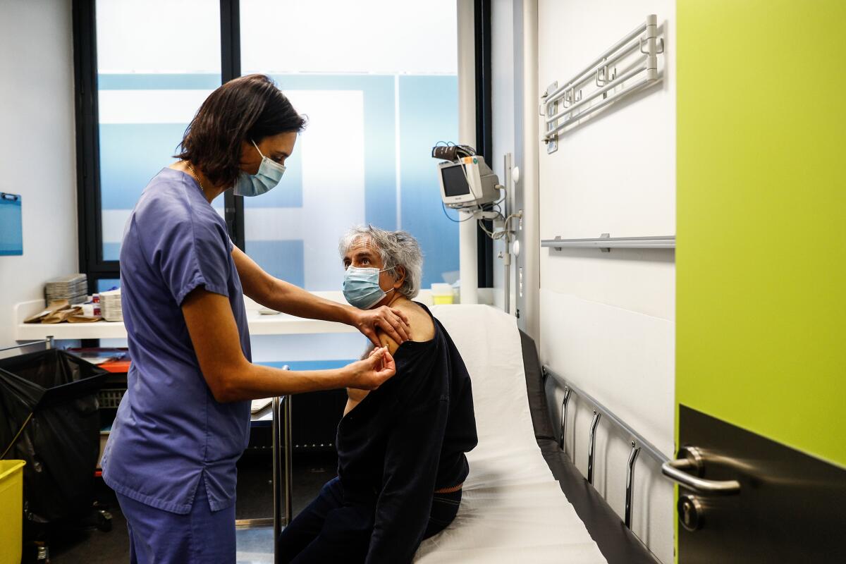 A nurse administers a dose of the Pfizer-BioNTech COVID-19 vaccine at the Hotel-Dieu hospital in Paris on Saturday.