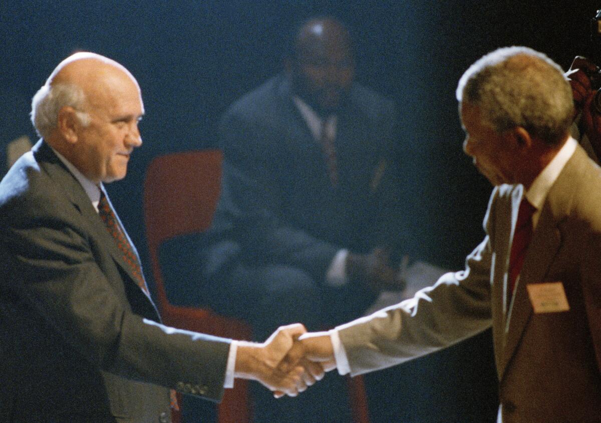 Then-South African President F.W. de Klerk shaking hands with Nelson Mandela