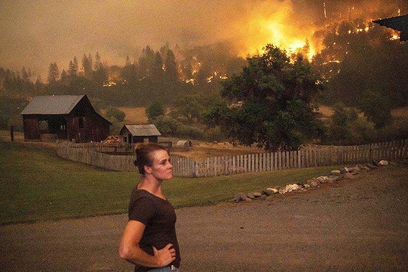 Angela Crawford watches the McKinney fire from her home in Klamath National Forest on Saturday.