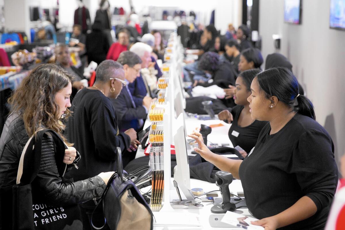 Customers check out at the new Century 21 department store in Philadelphia.