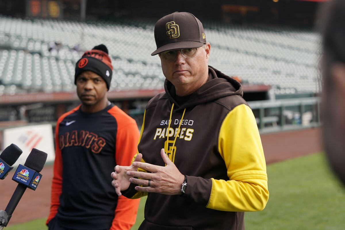 Padres third base coach Mike Shildt speaks to the media while standing next to Giants coach Antoan Richardson 