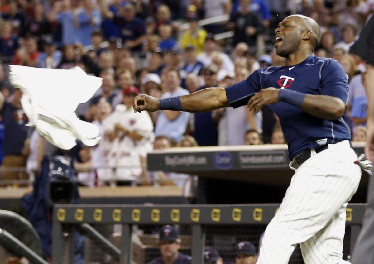 Minnesota Twins’ Torii Hunter tosses his jersey following his ejection in the eighth inning aginst the Kansas City Royals on Wednesday.