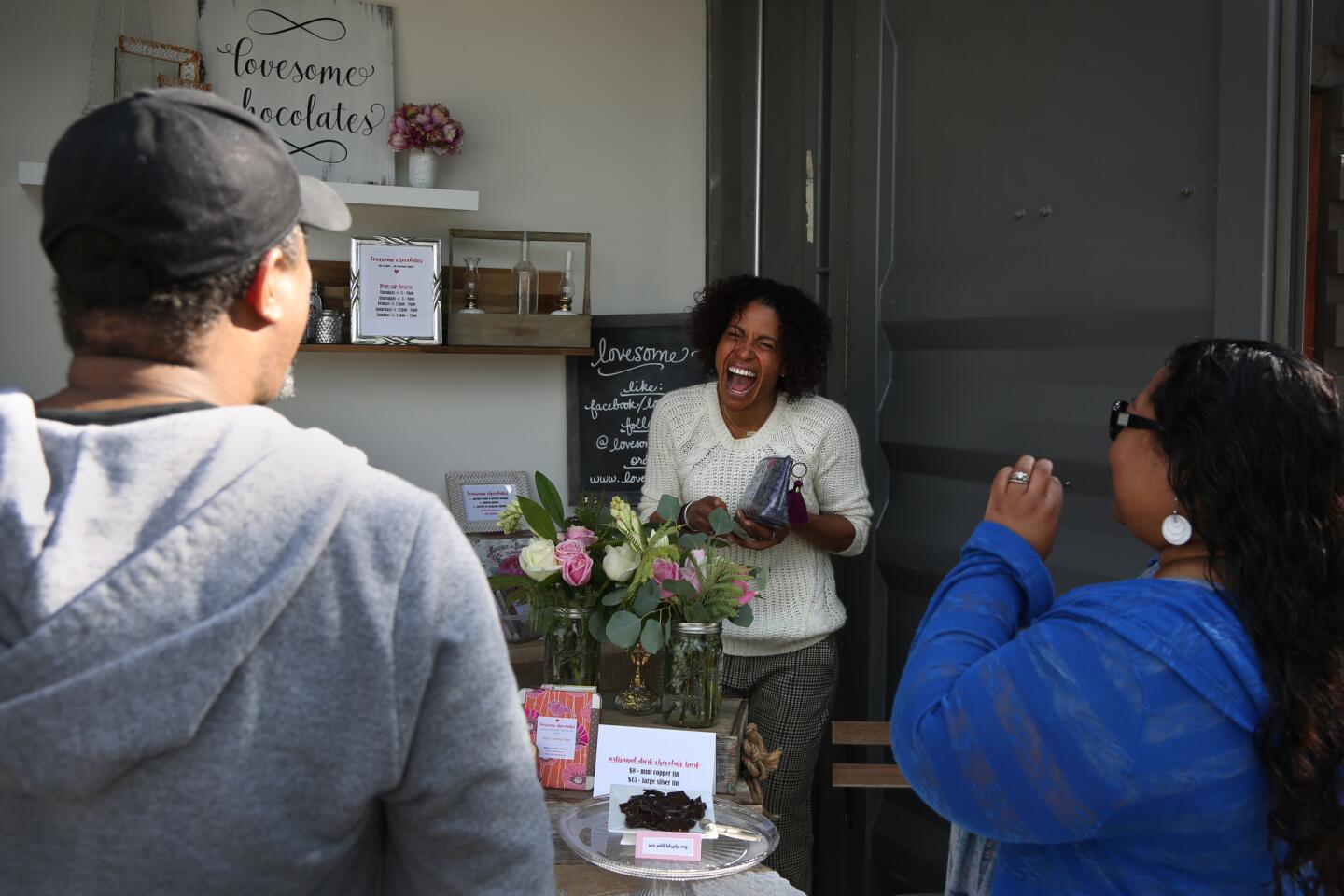 Nicole Moore, 47, center, spreads the love at her shop, Lovesome Chocolates, at Steelcraft in Long Beach.