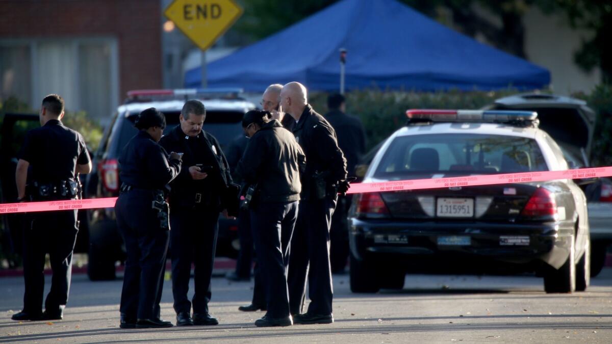 Investigators work the scene of a deadly 2015 shooting by a Los Angeles police officer in Burbank. Prosecutors announced Tuesday that they would not file criminal charges against LAPD Officer Brian Van Gorden, who shot and killed Sergio Navas after a car chase.