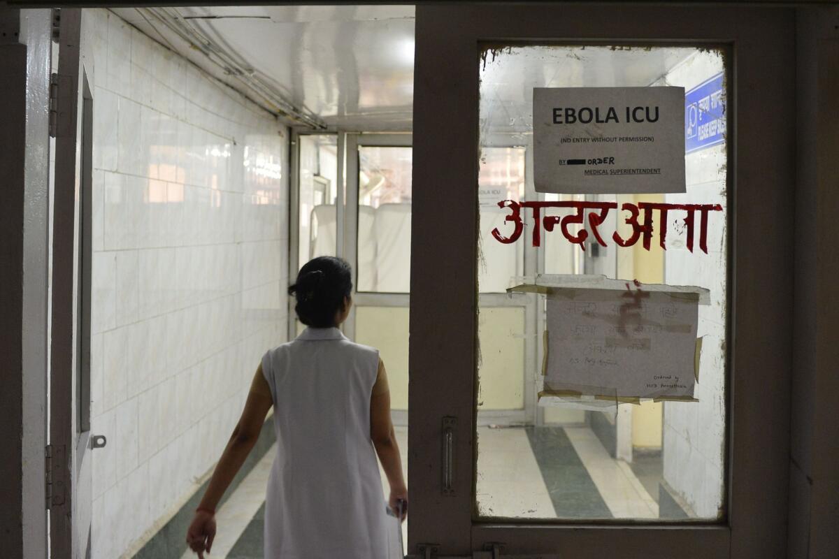 A nurse walks toward an intensive care unit for potential Ebola patients at a hospital in New Delhi. Officials say they have isolated a man whose semen tested positive for the disease weeks after he recovered from Ebola in Liberia.