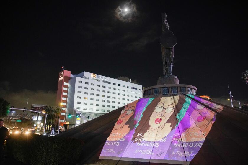 Tijuana, Baja California - January 23: Two years after the murder of Lourdes Maldonado, Tijuana journalists raised their voices to demand justice for their colleague. Members of YoSiSoyPeriodista gather at the Cuauhtemoc roundabout. A cartoon image of Lourdes is projected onto the monument in Zona Rio on Tuesday, Jan. 23, 2024 in Tijuana, Baja California. (Alejandro Tamayo / The San Diego Union-Tribune)