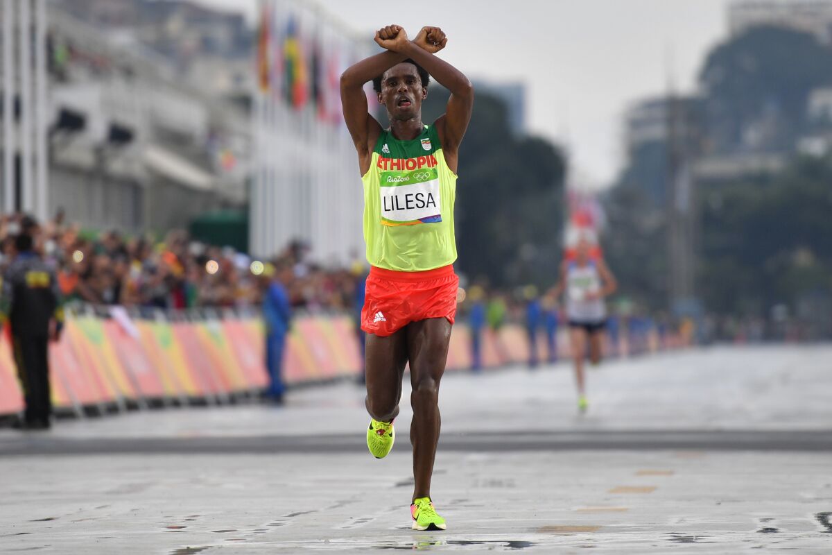 Ethiopia's Feyisa Lilesa crosses his arms in solidarity with protesters in his country during the Rio 2016 Olympics.