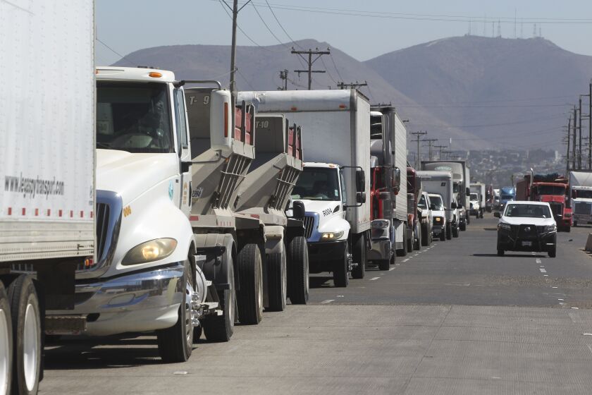 Commercial trucks wait in line to cross at the Otay Mesa Port of Entry on Friday, August 30, 2019 in Tijuana, Mexico.