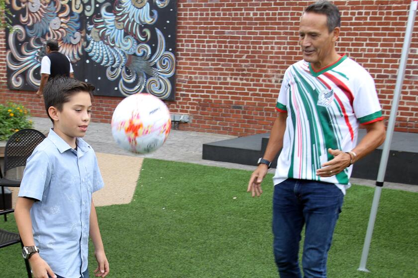Mexican soccer legend Luis Hernandez plays soccer with Aden Camarillo.