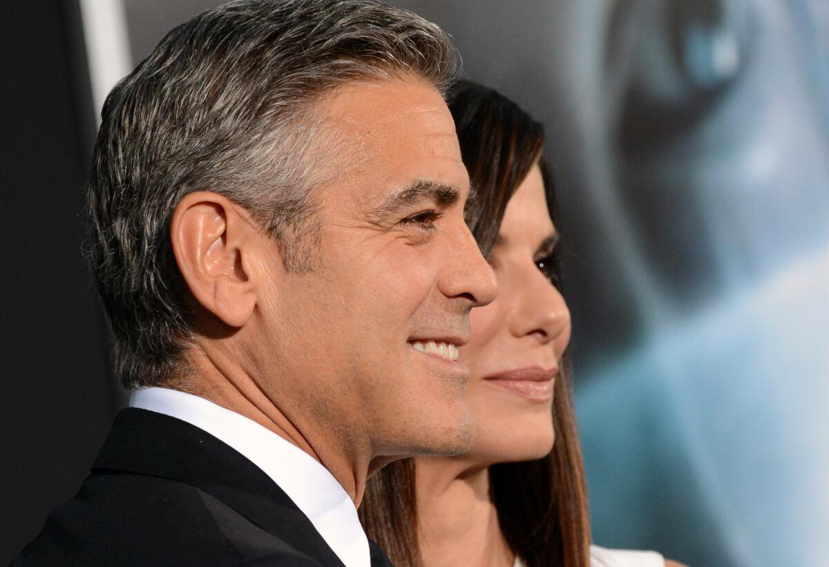 Actors George Clooney and Sandra Bullock attend the premiere of "Gravity" in New York on Oct. 1, 2013.