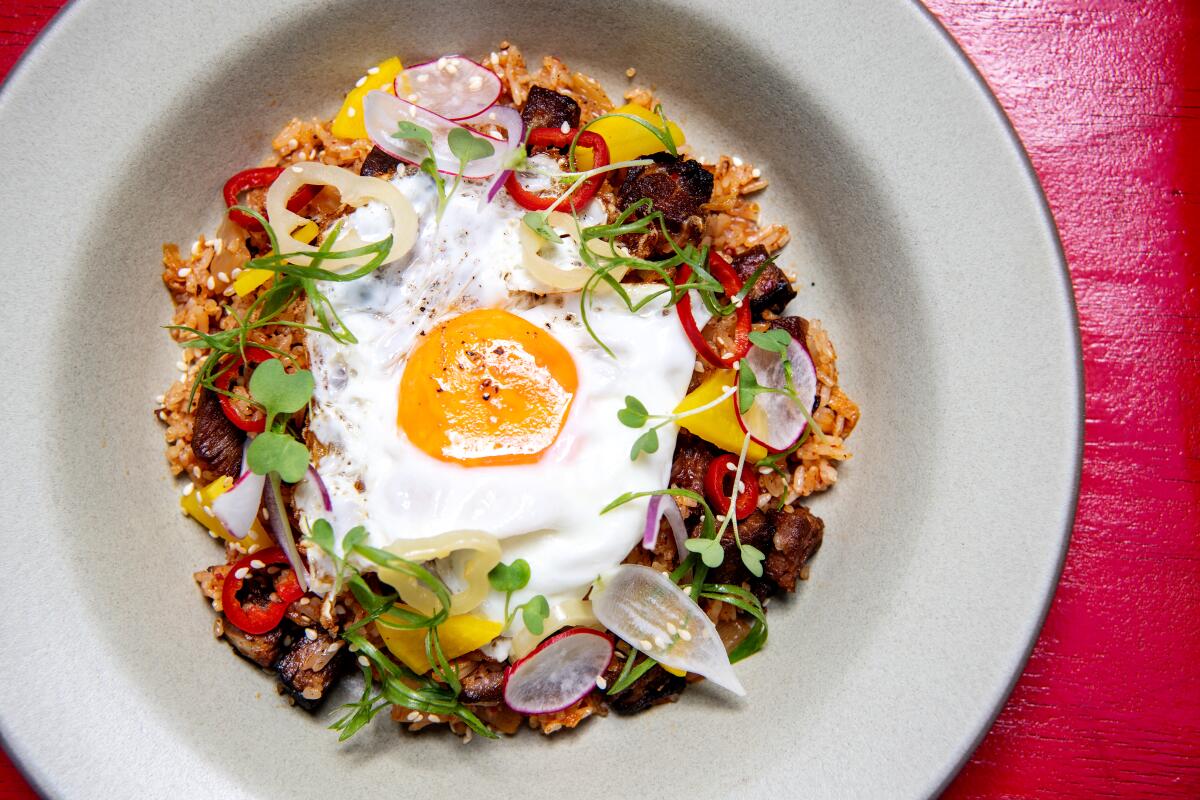 Kimchi fried rice with short rib, pickled radish and soft poached egg