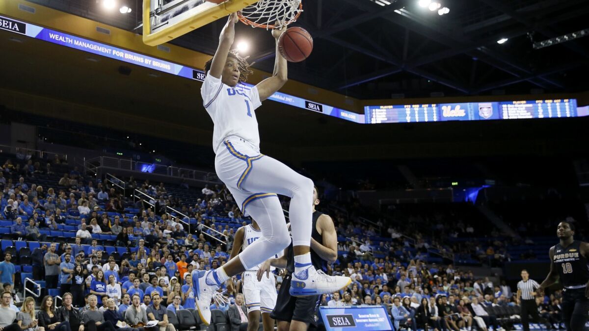 UCLA center Moses Brown dunks on an alley-oop pass from guard Prince Ali during a game against Purdue Fort Wayne on Nov. 6.