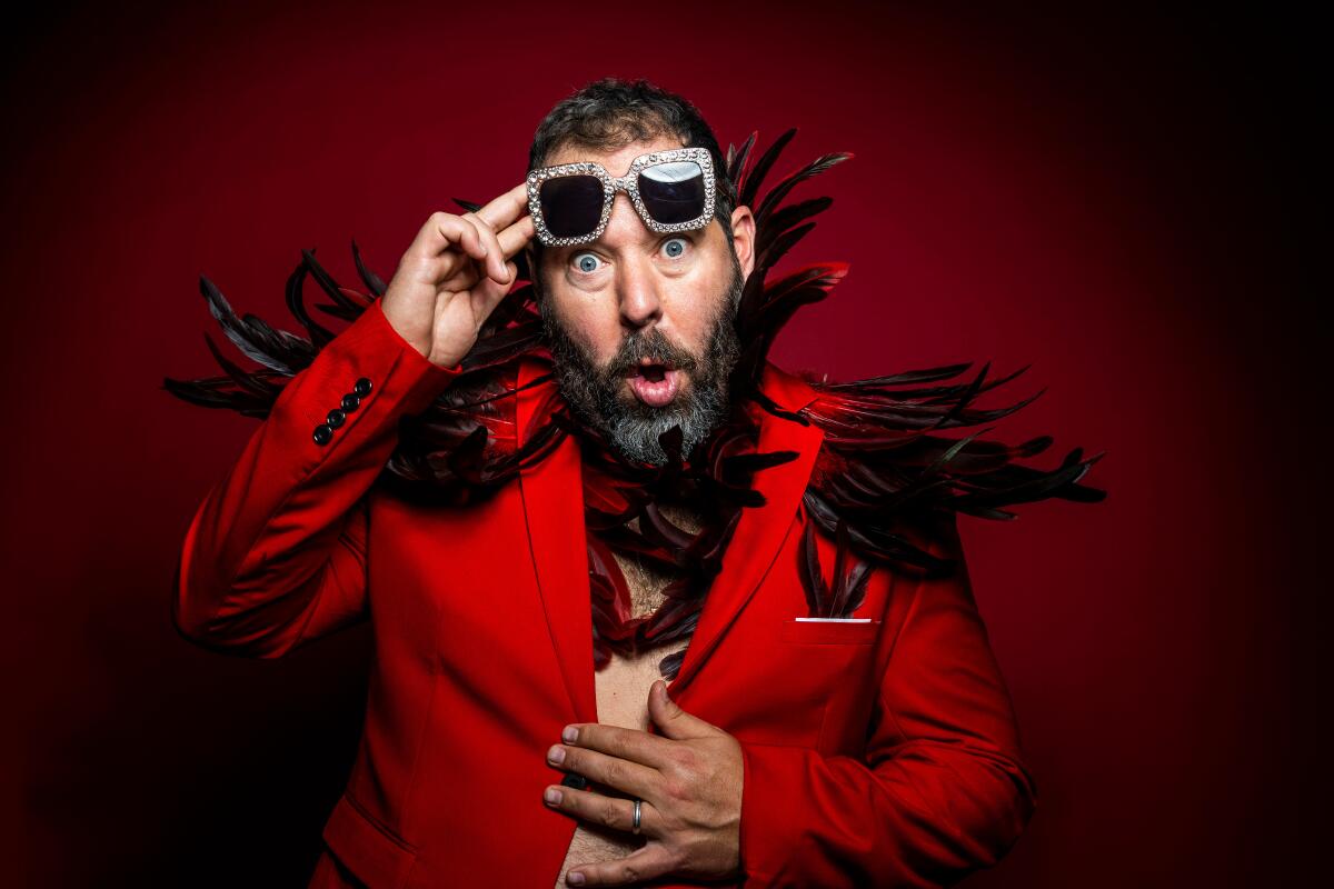 Man in red feathered suit and red glasses 
