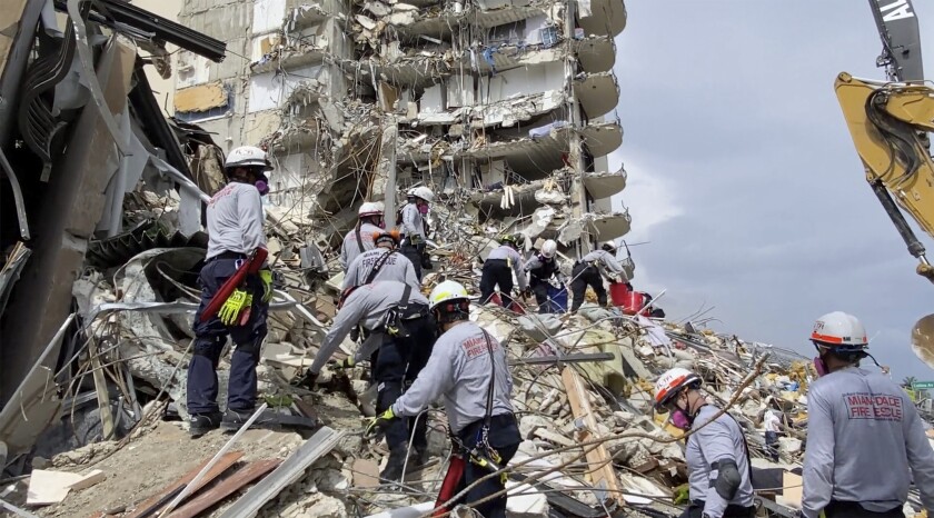 Rescue workers search for survivors Friday amid the rubble of the Champlain Towers South building in Surfside, Fla.