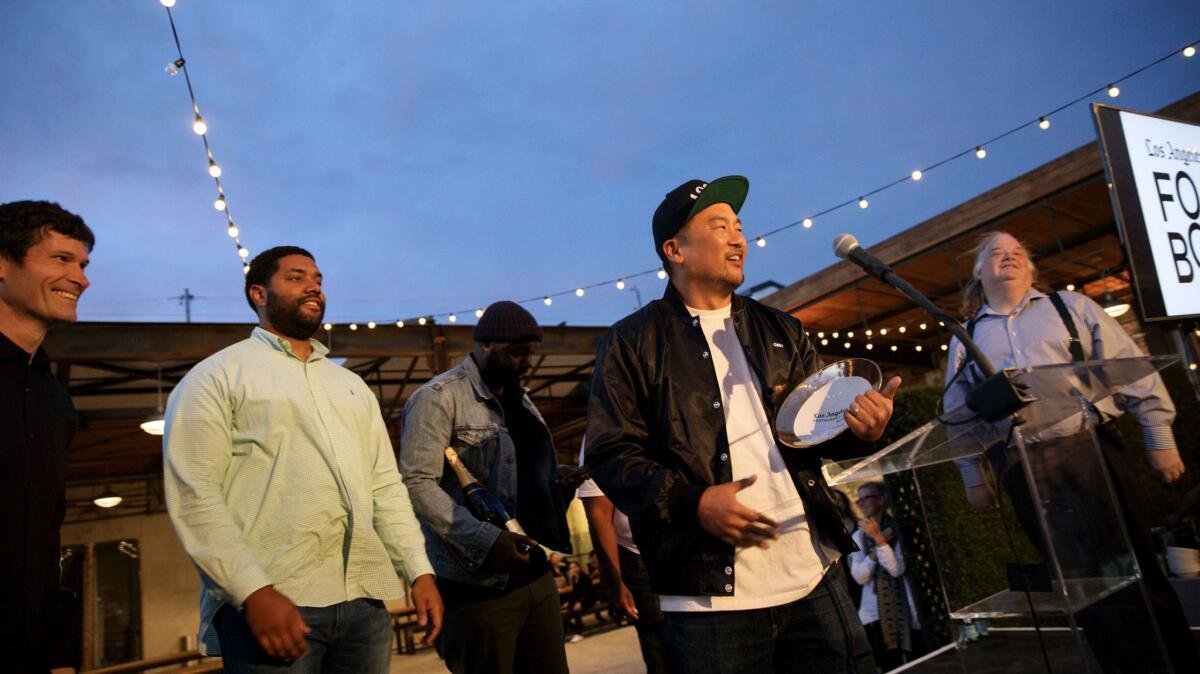 Chef Roy Choi of Locol, center, is presented with the restaurant of the year award by Times restaurant critic Jonathan Gold.