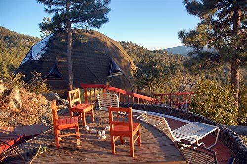 Brightly painted chairs add a touch of color on the patio next to a geodesic dome in Idyllwild, Calif. The dome and other rentals are an alternative for thrifty or just plain adventuresome travelers who are tired of motels and crave a home away from home while on vacation.